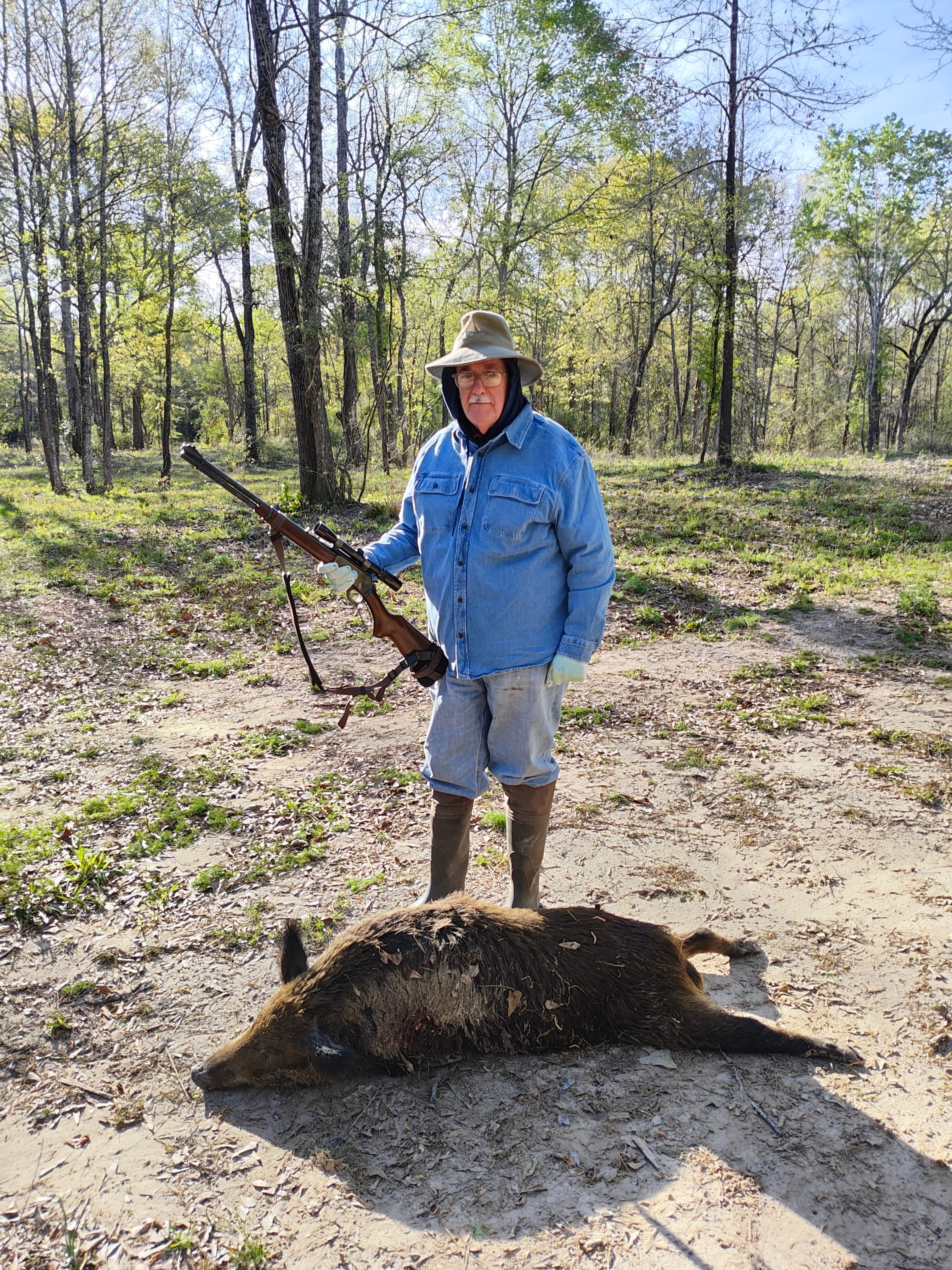 The author's father standing with a harvested sow