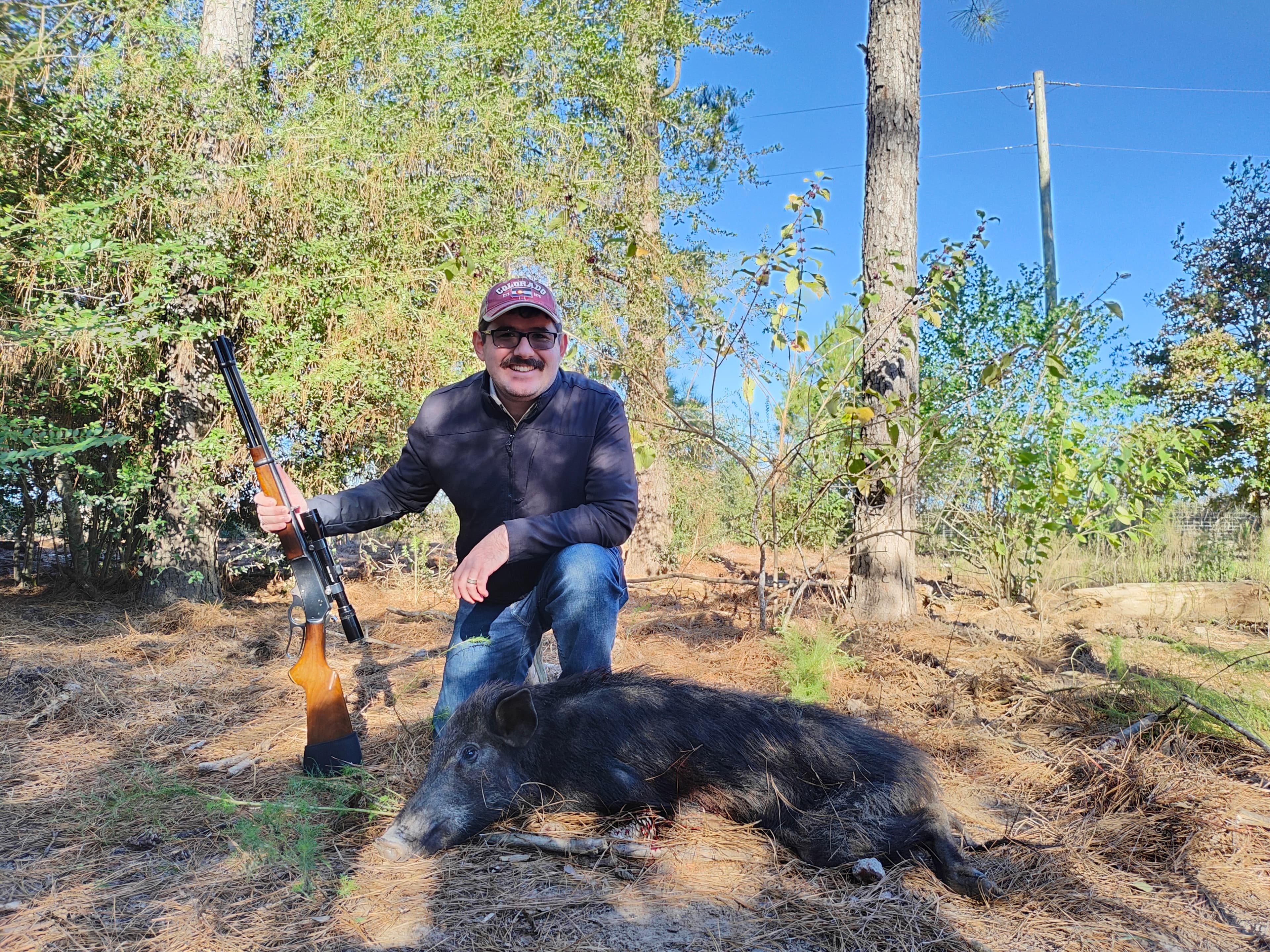 The author kneeling beside a harvested sow with a Marlin 336 rifle