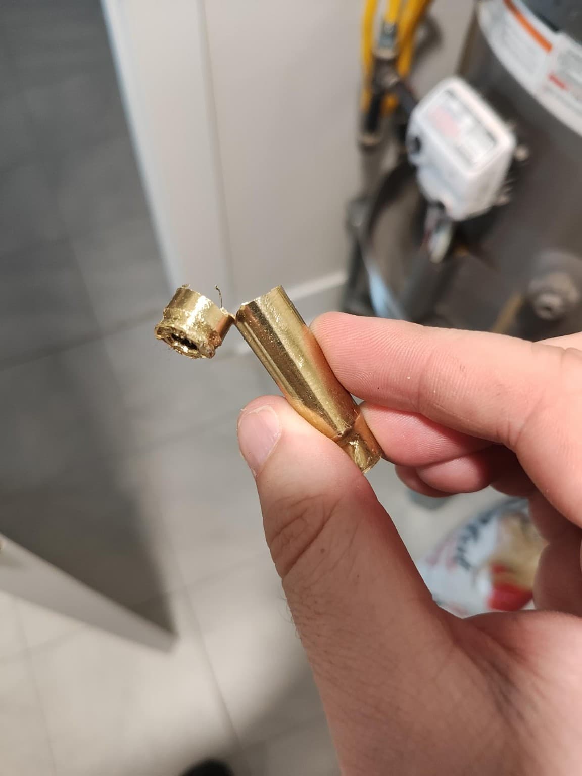 A cut-open cartridge case with its case head peeled back