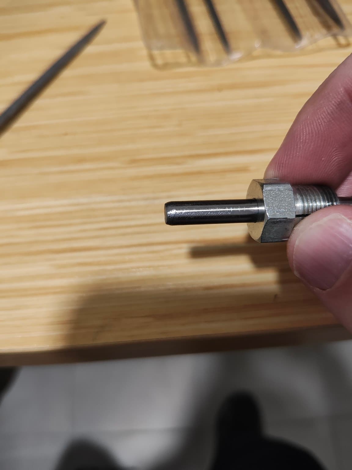 The filed and rounded mandrel seated through the lock screw